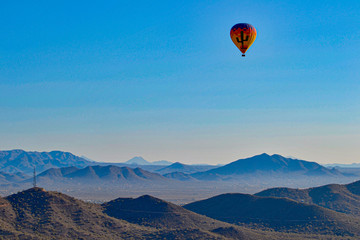 Hot Air Balloon floating over the Misty Mountains of the Arizona Desert near Phoenix