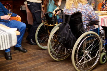 Obraz na płótnie Canvas unrecognizable man in wheelchair in cafe