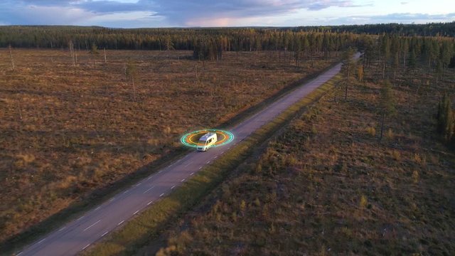 3D autopilot computer graphics symbol spinning over white camper van, while driving on road  in northern Sweden.