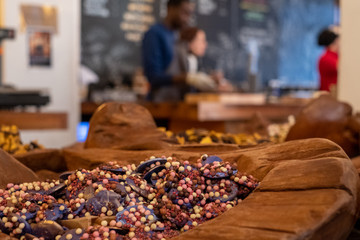 Handmade chocolates beautifully presented in wooden vessels at the Dark Sugars shop in Brick Lane, London, UK. Photographed at Christmas time.