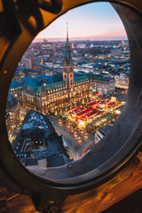 Top view of illuminated Christmas market on townhall square in advent time, Hamburg, Germany....