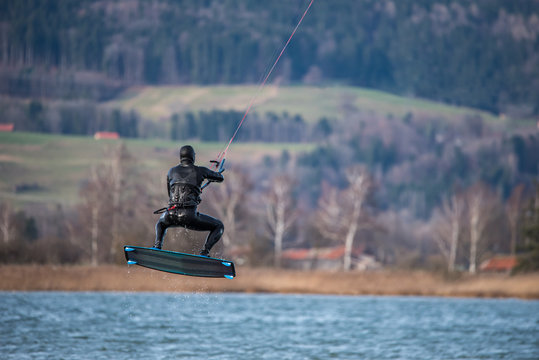 Kite surfer flying over the water with high speed