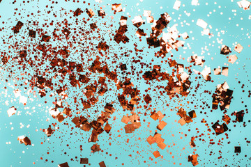Falling silver confetti on blue backdrop. Holiday concept.