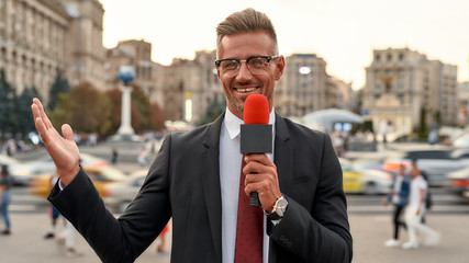 Here. There. Everywhere. Professional reporter presenting the news on urban street. Journalism...