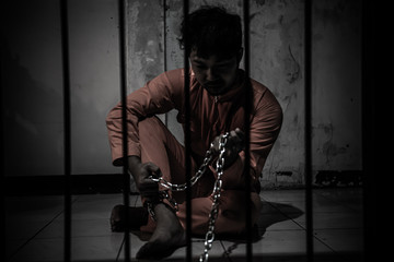 Asian man desperate at the iron prison,prisoner concept,thailand people,Hope to be free,Serious...