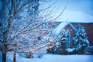 Winter landscape. Beautiful house covered snow at evening