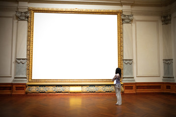 Woman with folded arms standing in front of and looking at big blank painting canvas with huge frame with negative area for your art and text. - obrazy, fototapety, plakaty