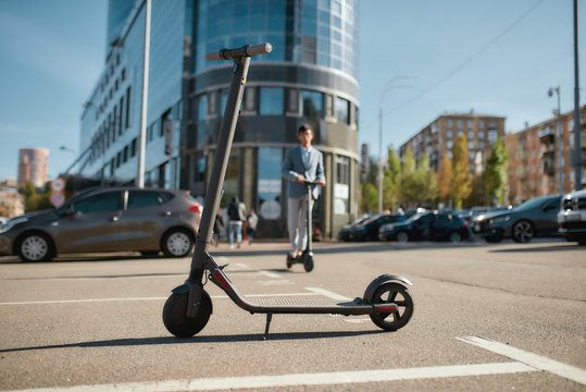 Try to use it. Rental electric scooter standing on the street