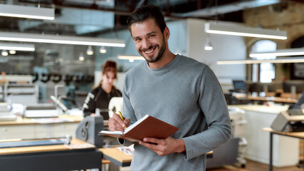 Your fate relies completely on your hard work. Young businessman posing in office