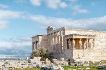 Fotobehang Panoramic view on the ruins of Erechtheion temple. Acropolis Hill in Athens. The surviving part of the colonnade. Figures of Caryatids Porch. Female statues. Blue sky. Traveling and vacation concept. © Denis Mamin