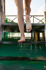  Unrecognizable woman climbs wooden dock stairs