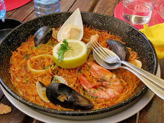 Delicious paella rice dish with mussels and prawns in Spain