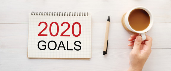 2020 goals on note book paper at office desk background, banner sign, 2020 new year business...