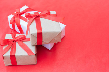 Close up three gift boxes. Red ribbon bow with gift boxes on red background, Wrapped vintage box with copy space