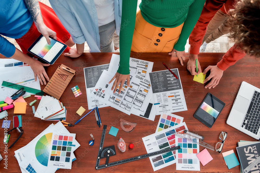 Aufkleber creating a brand book. top view of design team working on a new project in the creative office. grou