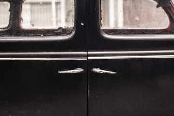 Fototapeta na wymiar door handles of old abandoned black car
