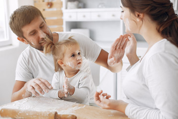 Family in a kitchen. Beautiful mother with little daughter. Family at home