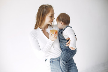 Beautiful woman with child. Woman in a white blouse. Little girl with fruits