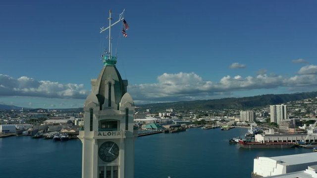 alt orbiting clockwise around iconic Aloha Tower revealing downtown Honolulu