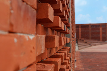 Red bricks wall material close up and blue sky