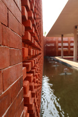 Red bricks wall material and pond