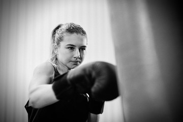 Fototapeta na wymiar young female keeping fit boxing