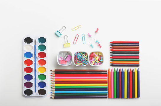Colorful art supplies organized on a white background