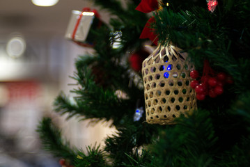 A hanging traditional bamboo basket is hanging on a mistletoe