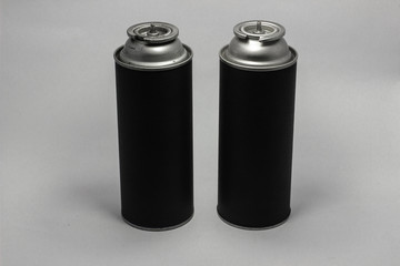 Black travel portable gas cylinder for burners with a white background.