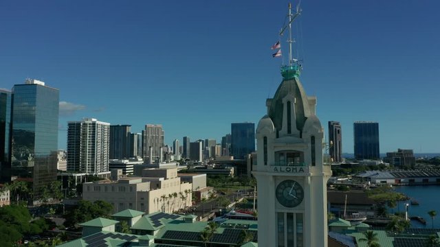 orbiting counter clockwise around iconic Aloha Tower revealing downtown Honolulu