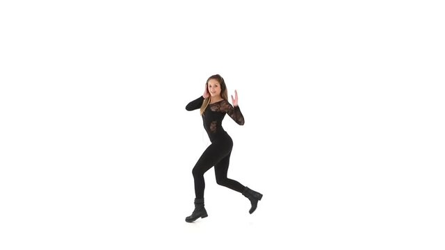 Young female hip-hop dancer dressed in black, performing on a white background