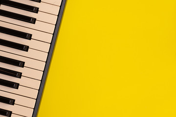 Top view piano keys over yellow background. pianist musician pianist concept.
