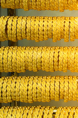 Shop display of dozens of golden bracelets