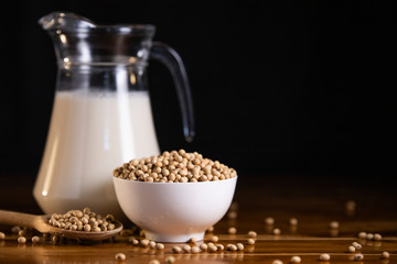 Soy milk hot and soybeans in cup on wooden table background