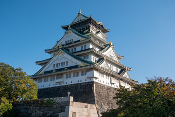 Osaka Castle in Osaka with autumn leaves. Japan Travel Concept