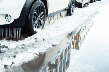 close up photo off car in iciles, a lot of water and snow, seasonal issues concept