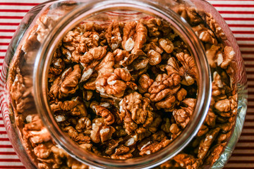 Stockholm, Sweden A big glass container of walnuts in a kitchen.