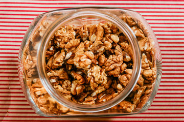 Stockholm, Sweden A big glass container of walnuts in a kitchen.