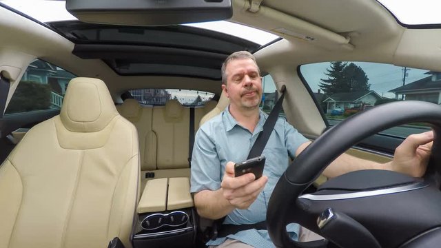 Distracted driver annoyed by excessive text messages on his smartphone