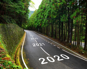 2020 to 2043 on highway and white marking lines in the forest, Happy new year and road to success concept
