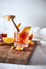 Alcoholic cocktail with orange peel and ice..