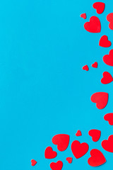 Valentine's Day design. Red hearts frame on blue background top-down copy space