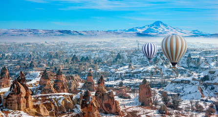 Hot air balloon flying over spectacular Cappadocia - Girls watching hot air balloon at the hill of Cappadocia