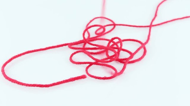 yarn color red fall on white screen.