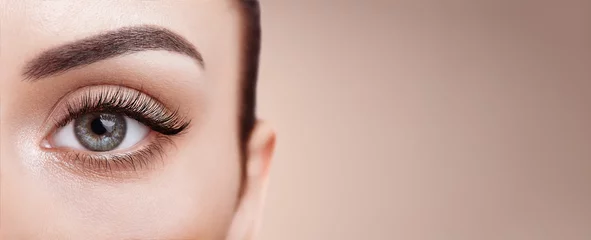 Fotobehang Female Eye with Extreme Long False Eyelashes. Eyelash Extensions. Makeup, Cosmetics, Beauty. Close up, Macro  © Oleg Gekman