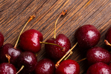 Berry cherry close-up. Ripe cherry on a wooden background.