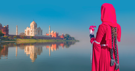 Braided girl with flower watching Taj Mahal, Agra- India