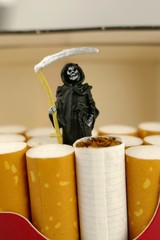 Smoking concept. smoking Death.Cigarettes  and a figure of death close-up in a cigarette pack. The...