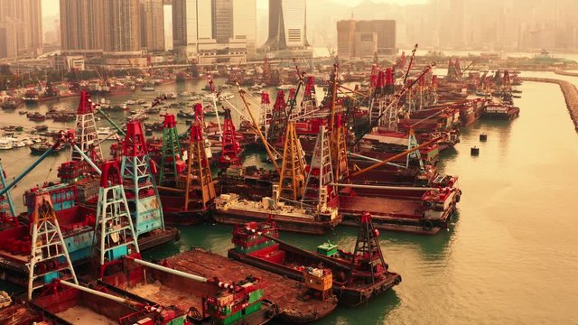 Boats in Hong Kong harbor in evening, cityscape of asian city, big harbor city, the capital on islands, trading boats