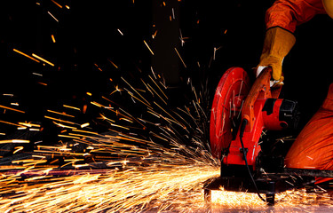 Grinding machine is cutting the metal and a lot of sparks